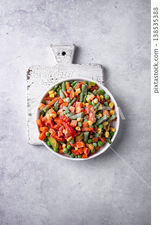 Frozen mix of vegetables on dark background Frozen mix of vegetables on dark background 138535388