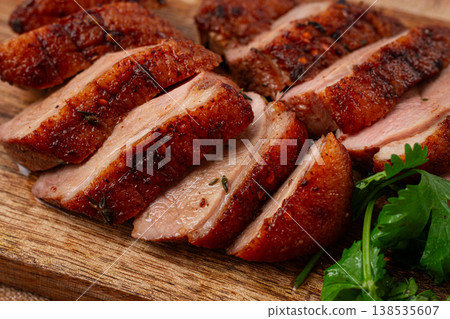 Roast duck breast, sliced, on a wooden chopping board,close-up, no people, Roast duck breast, sliced, on a wooden chopping board,close-up, no people, 138535607
