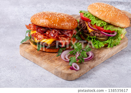 two burgers with beef patty, fried bacon, cheddar cheese, tomatoes, homemade, no people, two burgers with beef patty, fried bacon, cheddar cheese, tomatoes, homemade, no people, 138535617