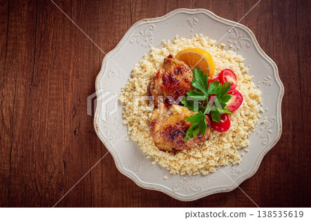 couscous with fried chicken, on a plate with lemon and parsley, Greek cuisine, homemade, no people, couscous with fried chicken, on a plate with lemon and parsley, Greek cuisine, homemade, no people, 138535619