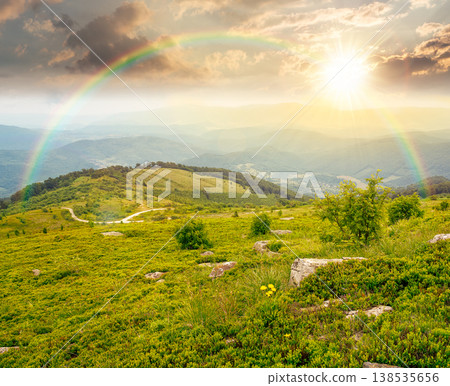 sunset over summer landscape of alps. hillside meadows in mountain scenery. countryside highland view from the top of a hill. nature background with green slope. weather with rainbow sunset over summer landscape of alps. hillside meadows in mountain scenery. countryside highland view from the top of a hill. nature background with green slope. weather with rainbow 138535656