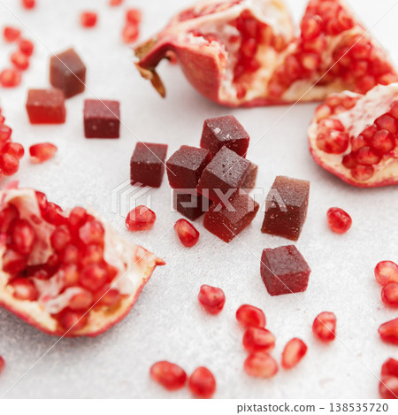 Home made candied fruit jelly with pomegranate fruits on white. Marmalade jelly candies 138535720