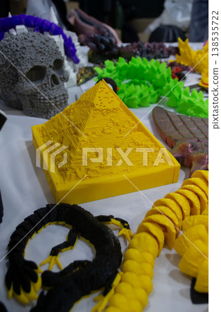 3D printed different art objects. Objects printed on 3D printer from melted colored plastic. Model yellow pyramid created on 3D printer from threads of molten plastic. Modern additive technologies 3D printed different art objects. Objects printed on 3D printer from melted colored plastic. Model yellow pyramid created on 3D printer from threads of molten plastic. Modern additive technologies 138535722