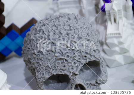 3D printed different art objects. Objects printed on 3D printer from melted colored plastic. Model gray skull created on 3D printer from threads of molten plastic. Modern new additive technologies 3D printed different art objects. Objects printed on 3D printer from melted colored plastic. Model gray skull created on 3D printer from threads of molten plastic. Modern new additive technologies 138535726