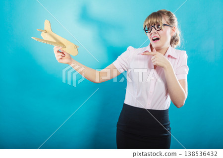 Fly fear. Woman holding airplane in hand. 138536432