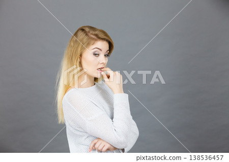 Blonde woman contemplating thinking about something Blonde woman contemplating thinking about something 138536457