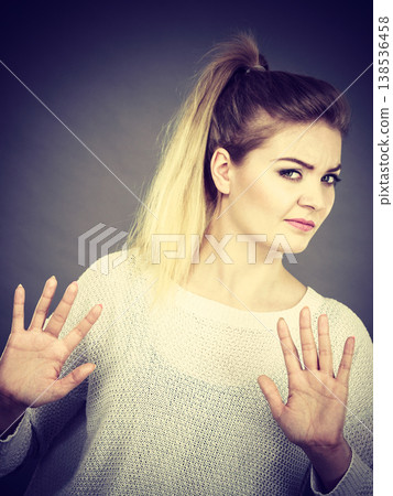Woman deny something showing stop gesture with hands Woman deny something showing stop gesture with hands 138536458