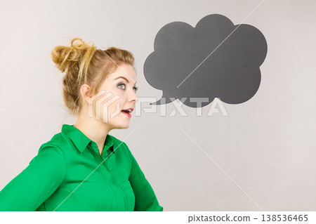 Woman holding black thinking bubble Woman holding black thinking bubble 138536465