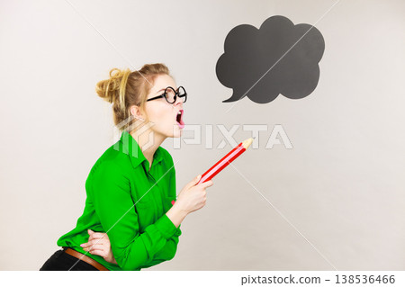 Angry teacher woman holding big pencil Angry teacher woman holding big pencil 138536466