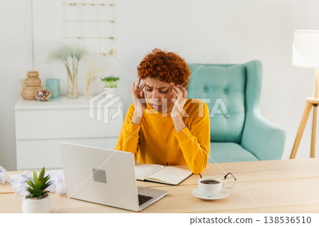 African woman touching temples experiencing stress. Girl at home office tired of working feeling headache sick rubbing temples forehead. Long laptop usage computer vision syndrome. Office syndrome African woman touching temples experiencing stress. Girl at home office tired of working feeling headache sick rubbing temples forehead. Long laptop usage computer vision syndrome. Office syndrome 138536510