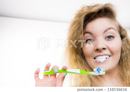 Woman brushing cleaning teeth Woman brushing cleaning teeth 138536638