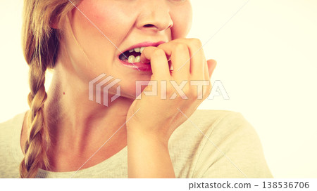 Scared, stressed woman biting her nails 138536706