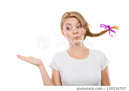 Happy teenage girl in braid hair presenting hand 138536707
