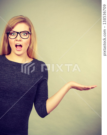 Nerdy woman in eyeglasses being confused Nerdy woman in eyeglasses being confused 138536709