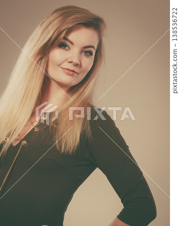 Attractive blonde woman wearing tight green khaki top Attractive blonde woman wearing tight green khaki top 138536722