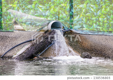 Photograph of water running out of a large PVC pipe Photograph of water running out of a large PVC pipe 138536803