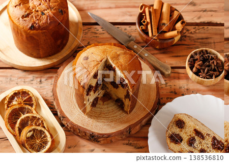 Chocolate panettone or chocotone, filled with creamy chocolate chips, presented in a Christmas setting on a rustic wooden board in Selective focus. A Christmas concept 138536810