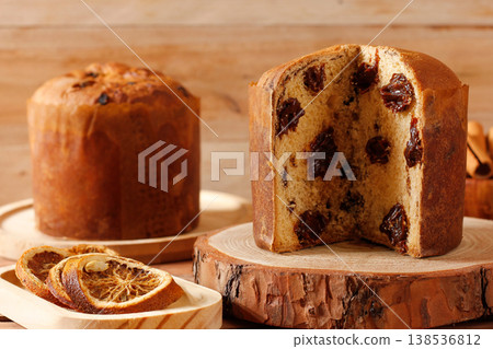 Chocolate panettone or chocotone, filled with creamy chocolate chips, presented in a Christmas setting on a rustic wooden board in Selective focus. A Christmas concept 138536812