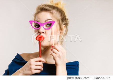 woman holds carnival accessories on stick woman holds carnival accessories on stick 138536926
