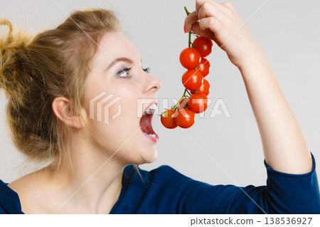 Woman holding fresh cherry tomatoes Woman holding fresh cherry tomatoes 138536927