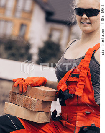 Strong woman building using bricks Strong woman building using bricks 138536961