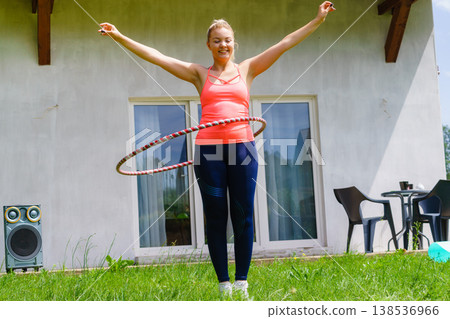 Young woman with hoola hoop outdoors Young woman with hoola hoop outdoors 138536966