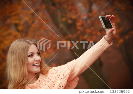Cheerful blonde girl taking selfie. Cheerful blonde girl taking selfie. 138536992