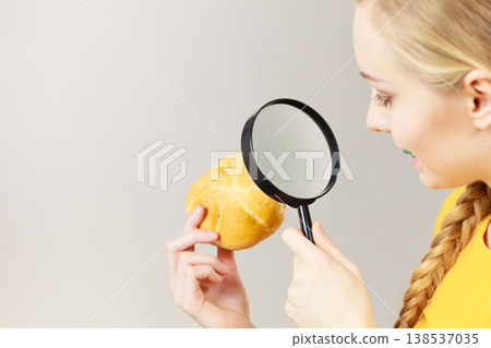 Bun bread roll and magnifying glass 138537035