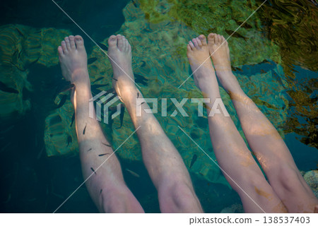 Feet in clear water with small fish around Feet in clear water with small fish around 138537403