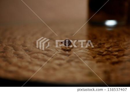 Diamond engagement ring on glass surface with woven texture Diamond engagement ring on glass surface with woven texture 138537407