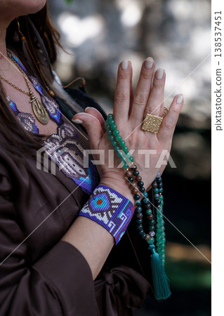 Woman hands with gold ring and turquoise beaded necklace 138537451