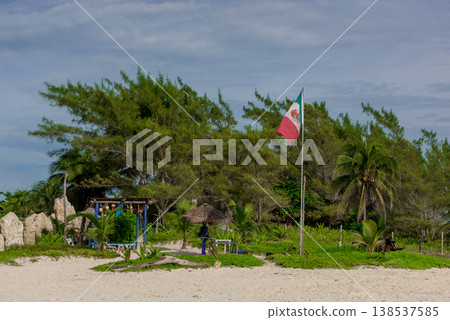 Mexican flag at rustic beachside cabana retreat 138537585