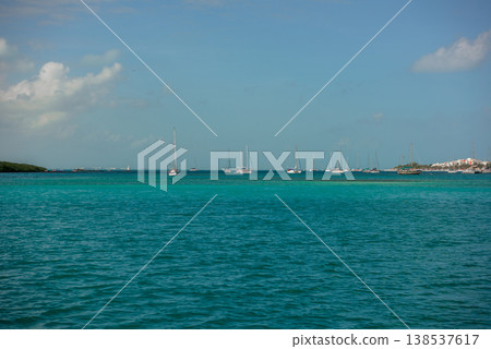Sailboats anchored in turquoise tropical bay waters 138537617