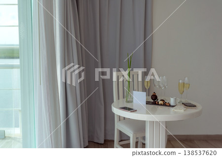 Romantic champagne setup in elegant hotel room corner Romantic champagne setup in elegant hotel room corner 138537620