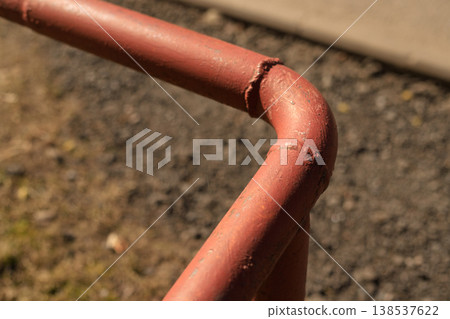 Close-up of a red metal water pipe with a welded joint. Industrial plumbing infrastructure 138537622