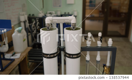 Industrial reverse osmosis water purification system with white filters and pipes in a workshop Industrial reverse osmosis water purification system with white filters and pipes in a workshop 138537944