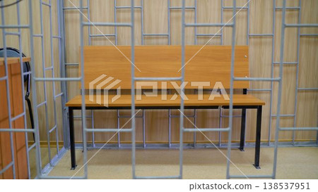 Empty bench in courtroom cage waiting for the defendant Empty bench in courtroom cage waiting for the defendant 138537951