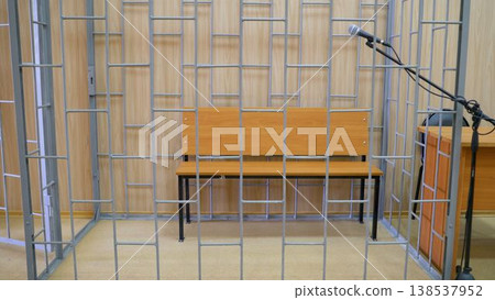 Courthouse interior. Interior view of the courtroom. Cage and bench in the court. Courthouse interior. Interior view of the courtroom. Cage and bench in the court. 138537952