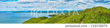 The nature of the Khasansky district of Primorsky Krai, Russia. The lip of the Teal of the Slavic Bay, the inner bay of Peter the Great in the summer. Panorama. The nature of the Khasansky district of Primorsky Krai, Russia. The lip of the Teal of the Slavic Bay, the inner bay of Peter the Great in the summer. Panorama. 138538074