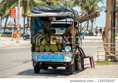 Mobile truck loaded with tropical fruits parked at touristic street selling durian fruit in Vietnam. Mobile truck loaded with tropical fruits parked at touristic street selling durian fruit in Vietnam. 138538087