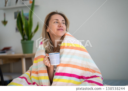 Happy optimistic woman drinking coffee in cozy bed in morning with positive uplifted expression. Happy optimistic woman drinking coffee in cozy bed in morning with positive uplifted expression. 138538244