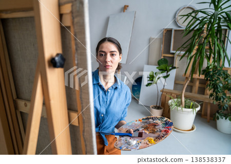 Concentrated woman artist dedicated art lover painting picture in loft studio, art hobby therapy. Concentrated woman artist dedicated art lover painting picture in loft studio, art hobby therapy. 138538337