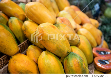 Papaya fruits fill shelves of food counter at asian market with ripe produce, grocery shopping Papaya fruits fill shelves of food counter at asian market with ripe produce, grocery shopping 138538509