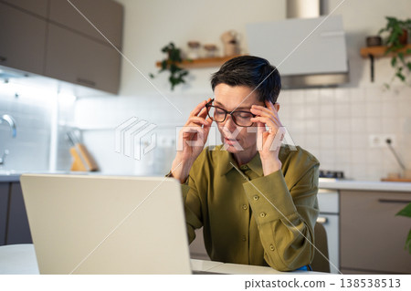 Stressed overworked senior businesswoman with burnout works on laptop, feeling exhausted and tired Stressed overworked senior businesswoman with burnout works on laptop, feeling exhausted and tired 138538513