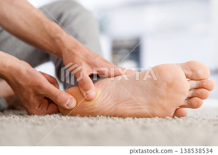 Man hands giving foot massage to yourself after a long walk Man hands giving foot massage to yourself after a long walk 138538534