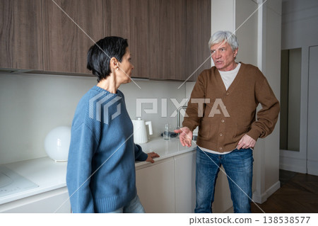 Enraged senior man yells at wife, tension erupt. Partners conflict, household stress in family Enraged senior man yells at wife, tension erupt. Partners conflict, household stress in family 138538577