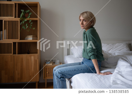 Thoughtful woman with blank expression staring at window engaged in deep thinking on life crisis. Thoughtful woman with blank expression staring at window engaged in deep thinking on life crisis. 138538585