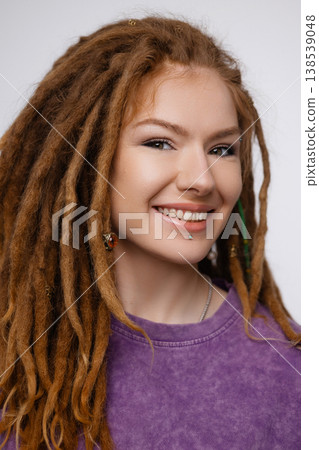 Smiling Caucasian woman with dreadlocks and piercing isolated on white background Smiling Caucasian woman with dreadlocks and piercing isolated on white background 138539048