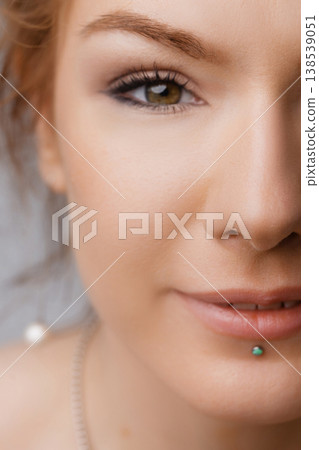 Extreme close up portrait of young Caucasian woman face with green eye and natural makeup Extreme close up portrait of young Caucasian woman face with green eye and natural makeup 138539051