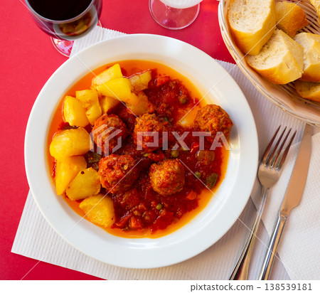 Albondigas meatballs with vegetable salsa and potato garnish Albondigas meatballs with vegetable salsa and potato garnish 138539181